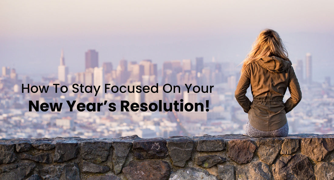 Article cover for '9 Ways to Stay Focused on Your Healthy New Year’s Resolution' with a woman sitting on a rock wall looking towards the city.