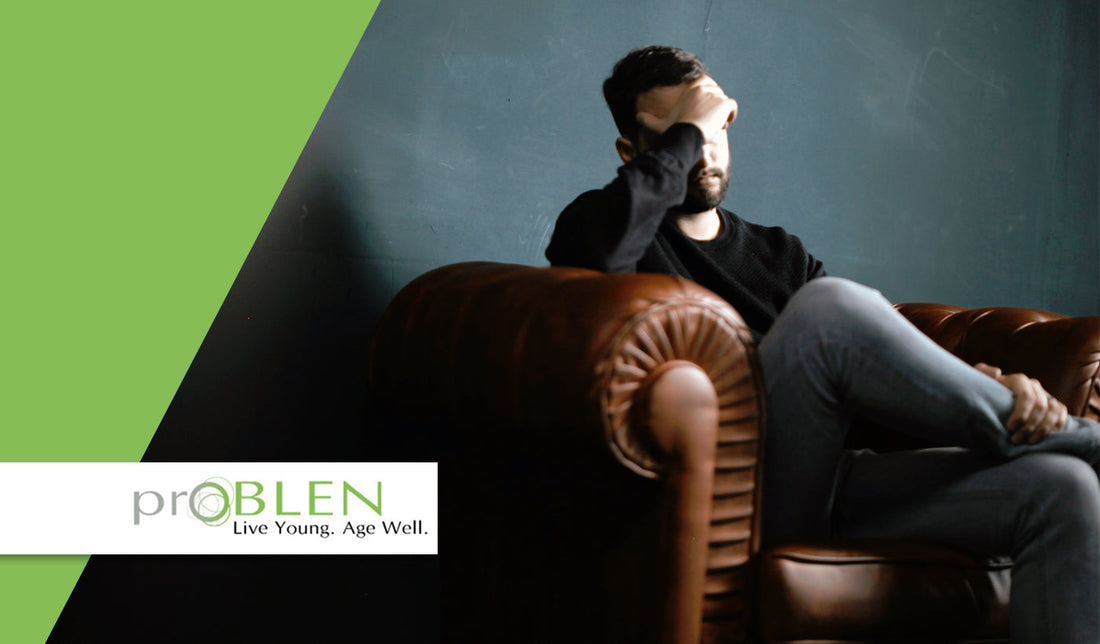 Article cover for 'How Metals Affect Our Bodies Every Day' with a man sitting on a couch with his hand over his head. - proBLENopathy